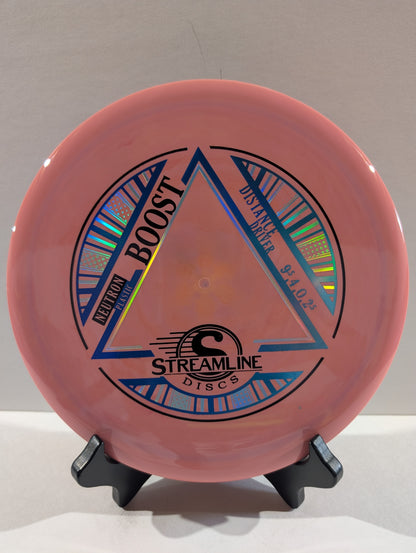 Pink disc with 'Streamline Discs' branding on a stand against a neutral background