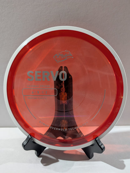 Disc golf disc with 'Servo' branding on a stand against a neutral background