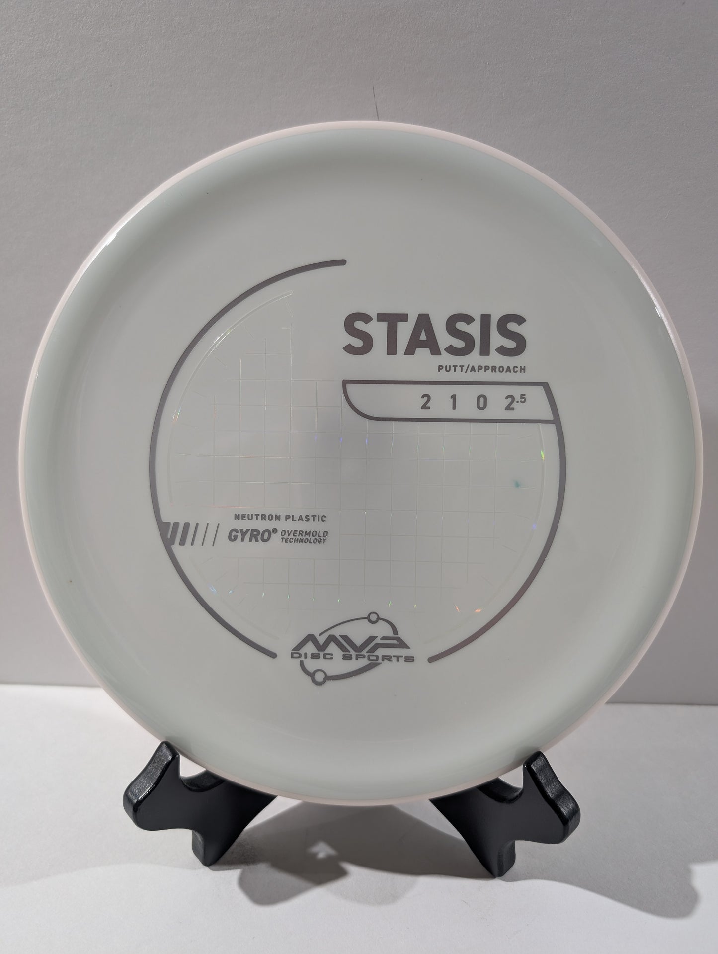 Disc golf disc with 'Stasis' branding on a gray background
