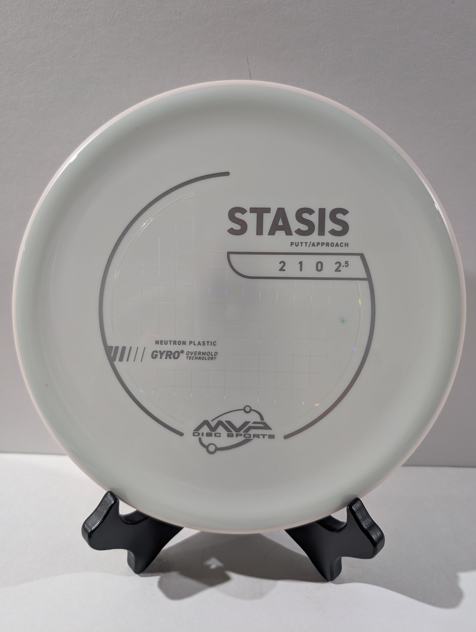 Disc golf disc with 'Stasis' branding on a gray background