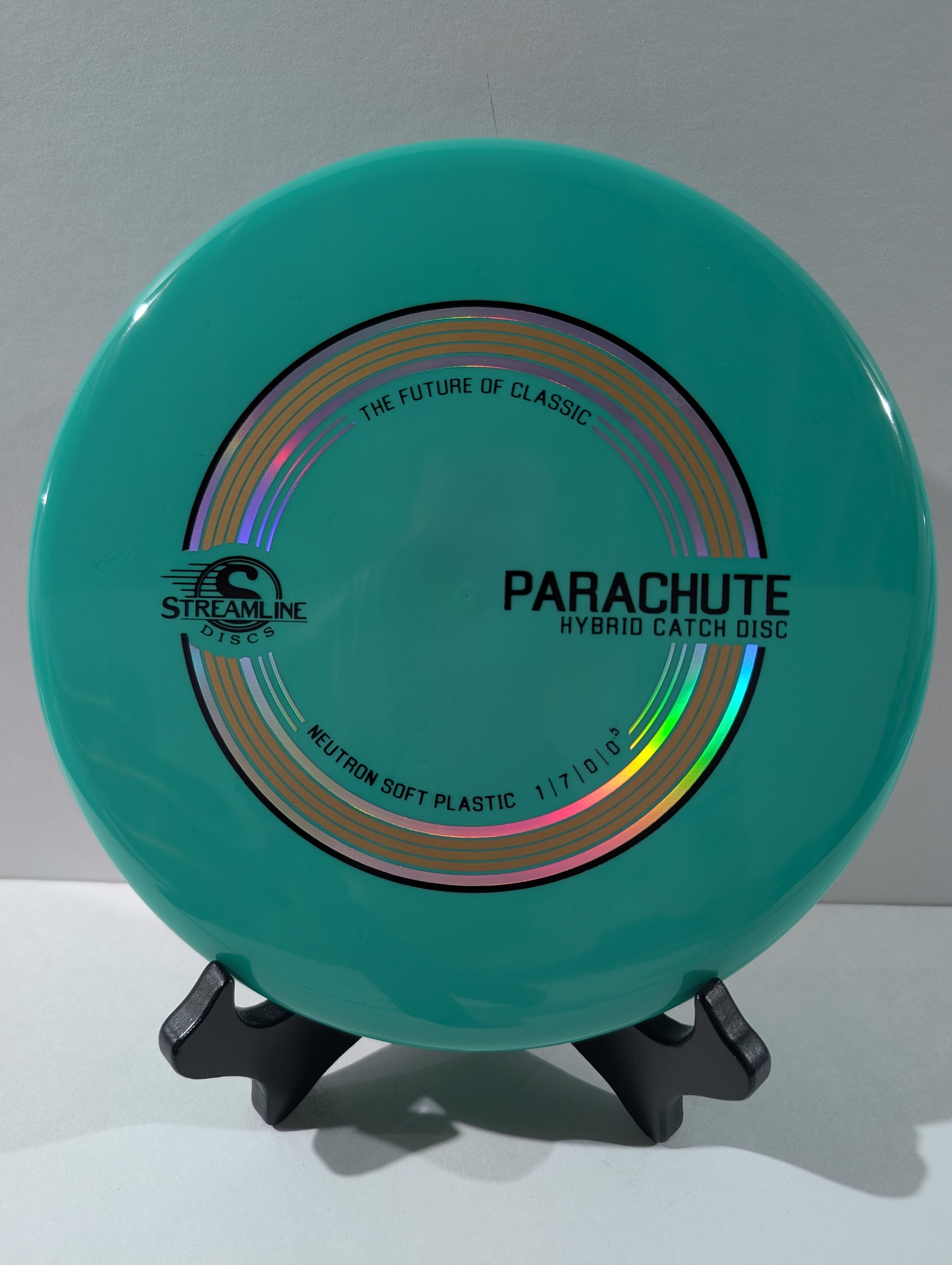 Turquoise disc with 'Parachute' branding on a gray background
