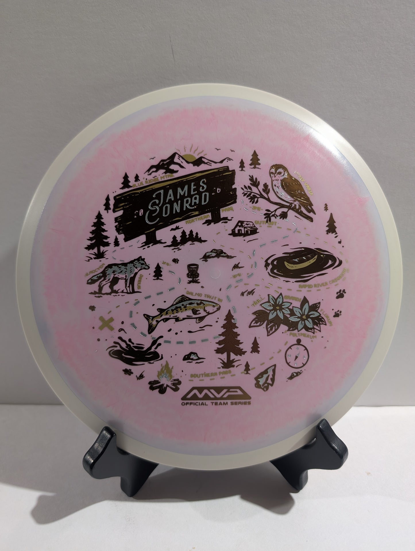 Pink disc with nature-themed designs and 'MVP' branding on a gray background