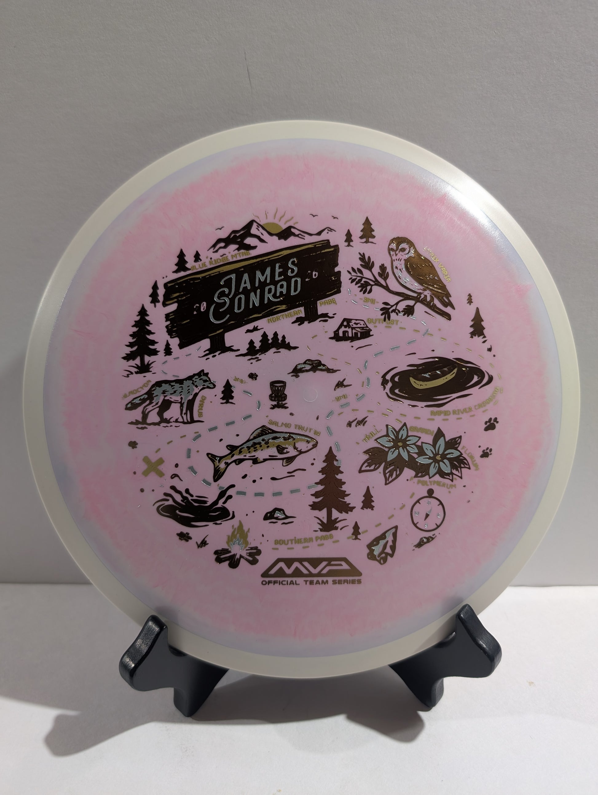 Pink disc with nature-themed designs and 'MVP' branding on a gray background