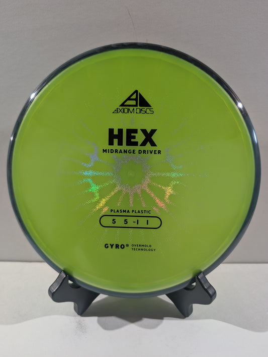 A lime green Axiom Discs Hex midrange disc golf driver displayed on a small black stand against a neutral light gray background.