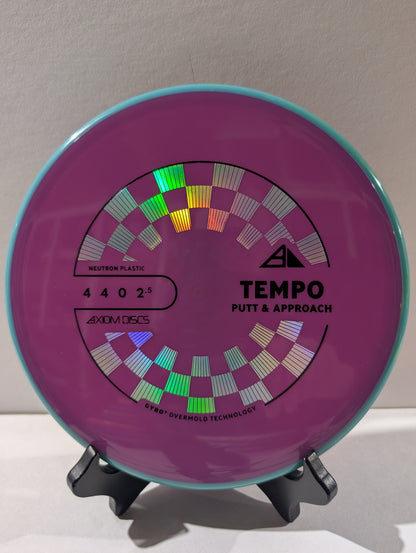 Purple and blue disc golf putter with 'Tempo' branding on a stand.