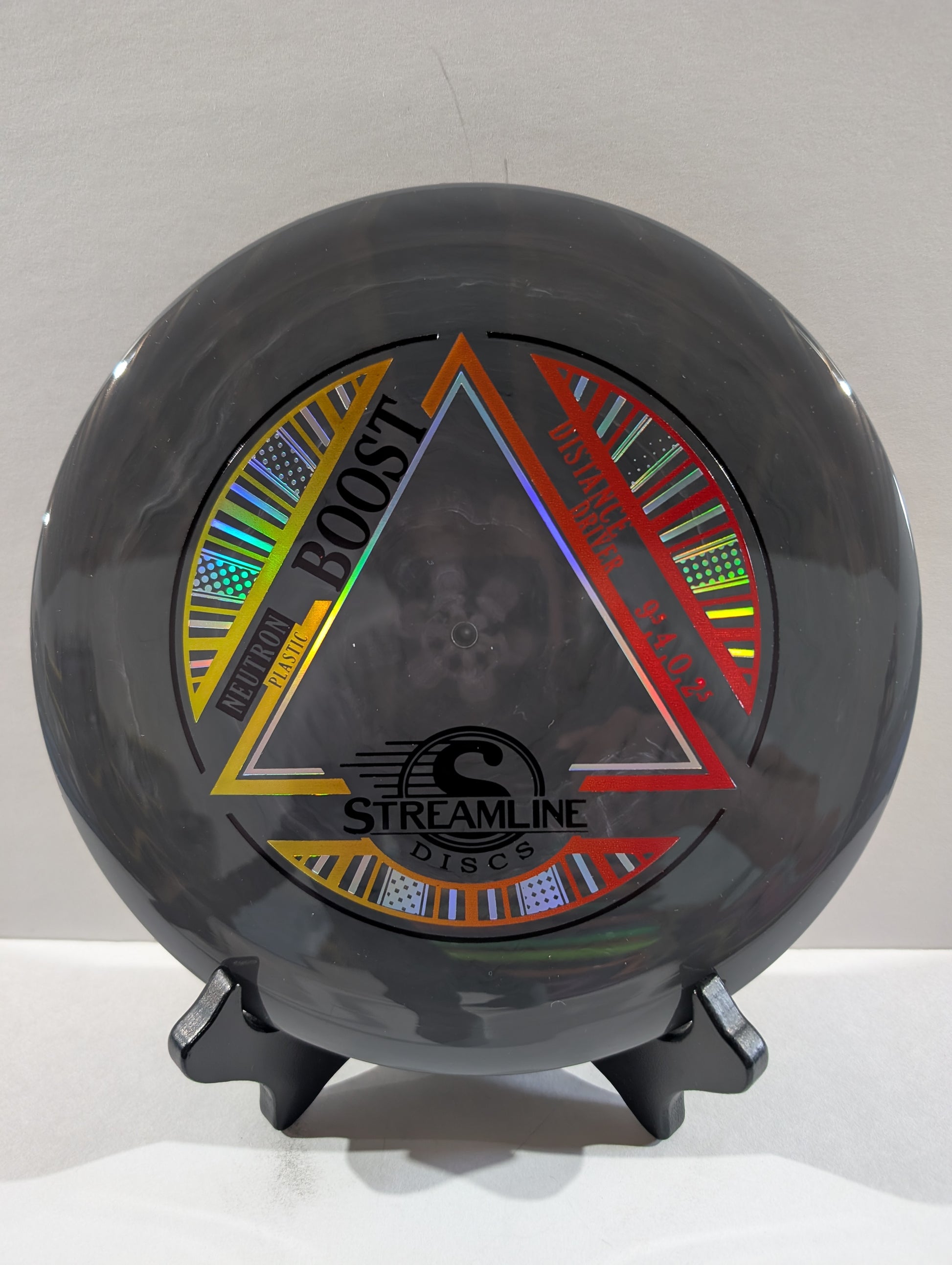 Dark grey disc with colorful design and 'Streamline Discs' branding on a white background
