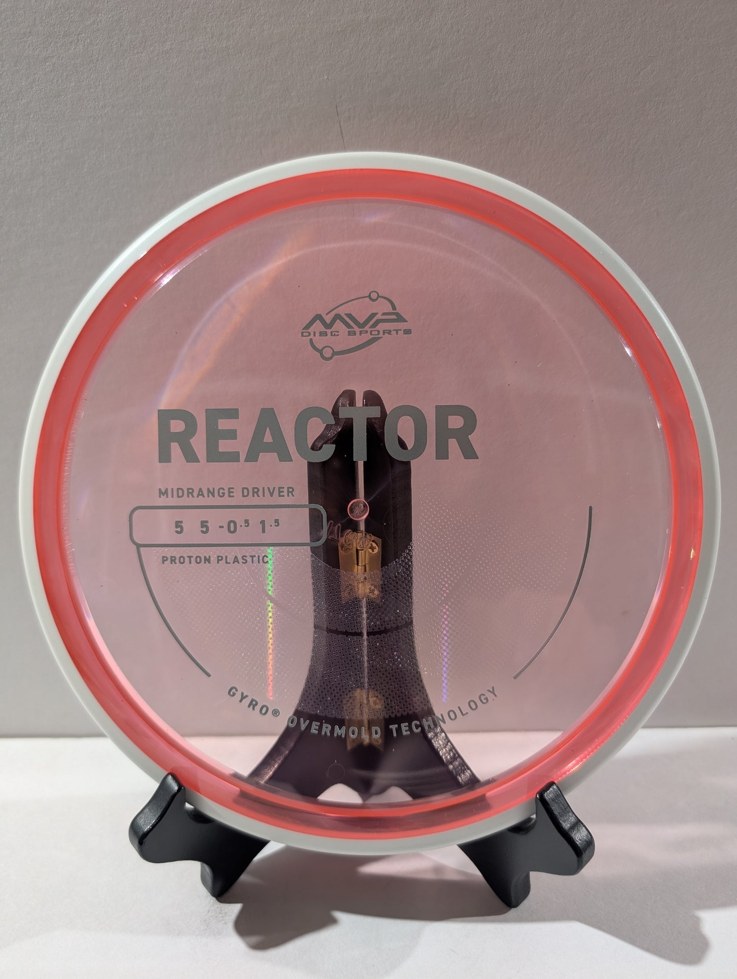 Disc golf disc with 'MVP Disc Sports' branding on a stand against a gray background