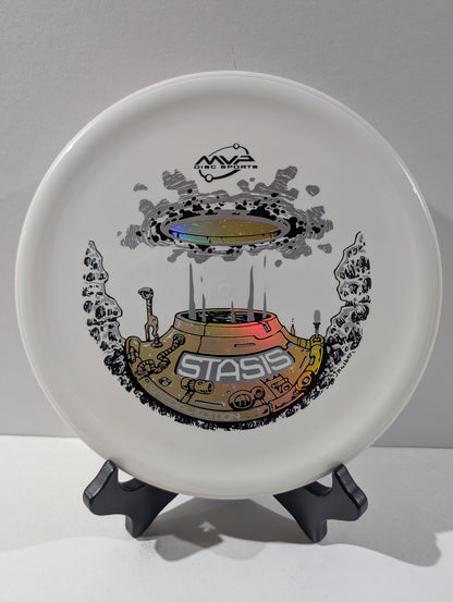 Disc with 'Stasis' design on a stand against a gray background