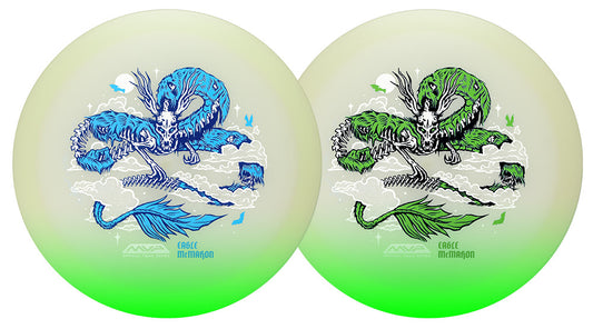 Two disc golf discs with a green-to-white gradient, each featuring a detailed dragon illustration and the text 'EAGLE MCMAHON' at the bottom.
